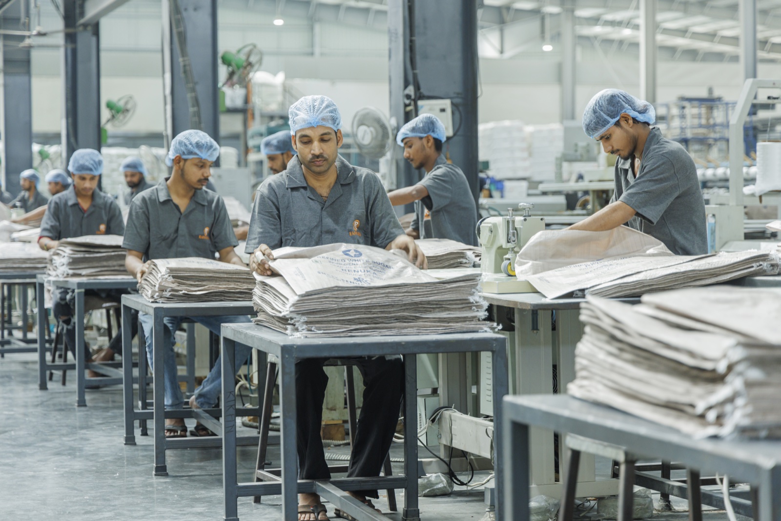 Aura Plastics workers at the bag stitching line